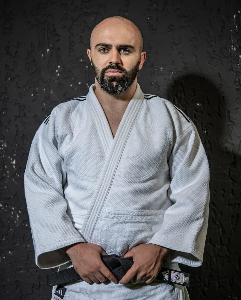 Vano Churchkhelashvili, judo coach at Gymnasia, in a judo gi and black belt